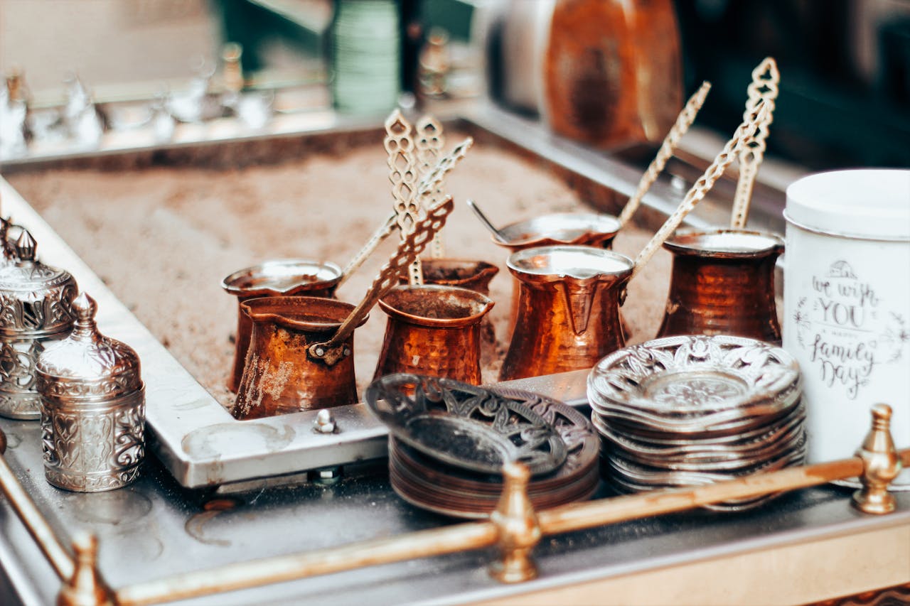 creative-01 Authentic Turkish coffee pots and ornate cups in a traditional market setting, showcasing cultural heritage.