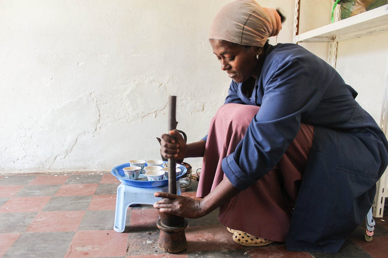 brand-03 Woman preparing coffee using traditional methods in Addis Ababa, Ethiopia.